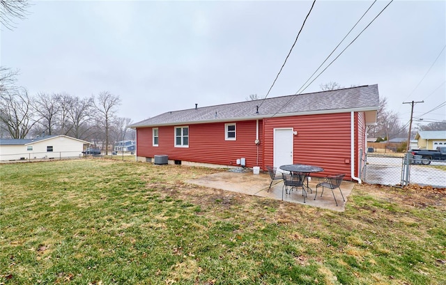 rear view of house featuring a yard, central AC, and a patio area