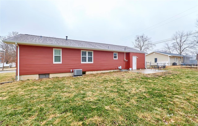 back of property featuring a trampoline, a yard, central AC unit, and a patio area