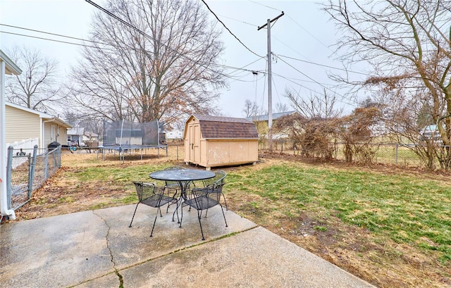 view of yard with a trampoline, a storage unit, and a patio