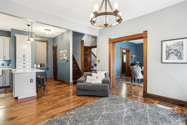 interior space with a notable chandelier and dark hardwood / wood-style flooring