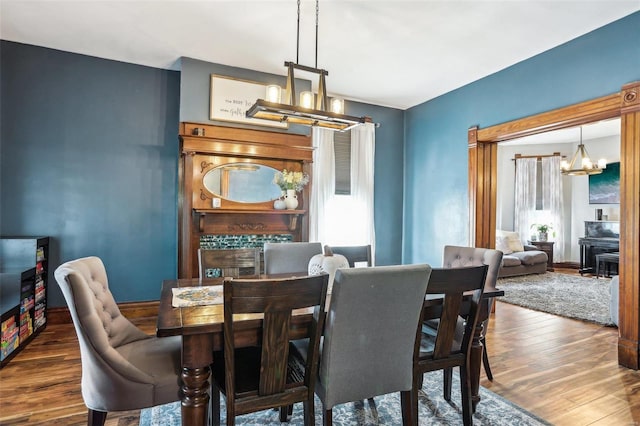 dining area featuring dark hardwood / wood-style floors and a notable chandelier