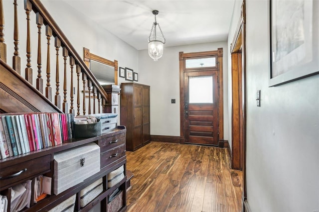 entrance foyer featuring a notable chandelier and dark wood-type flooring