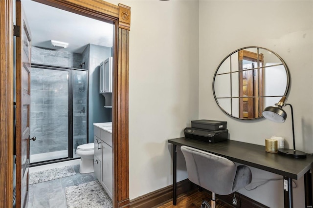 bathroom with walk in shower, vanity, and toilet