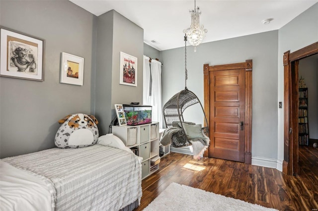 bedroom featuring dark hardwood / wood-style flooring and an inviting chandelier