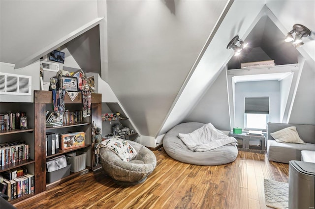 bonus room with lofted ceiling and wood-type flooring