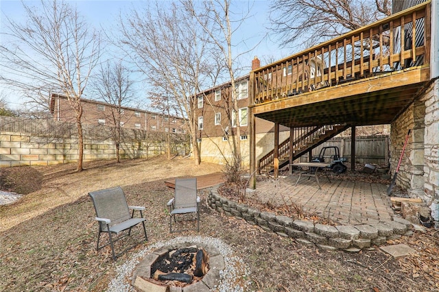 view of yard with a deck, a patio, and an outdoor fire pit