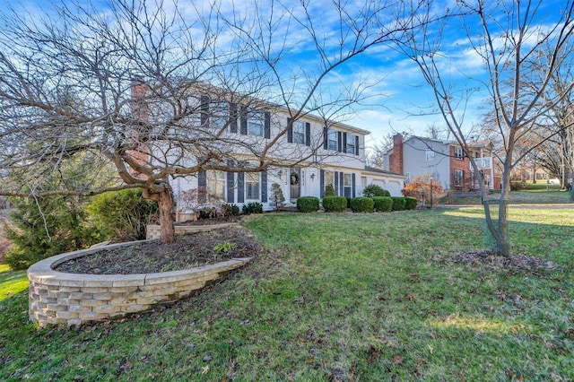 colonial inspired home featuring a front lawn