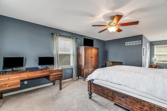 carpeted bedroom featuring ceiling fan and multiple windows