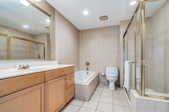 full bathroom with tile patterned floors, toilet, shower with separate bathtub, tile walls, and vanity