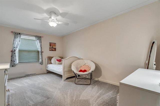 bedroom featuring ornamental molding, light colored carpet, and ceiling fan