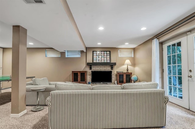 living room with light carpet, a fireplace, and french doors