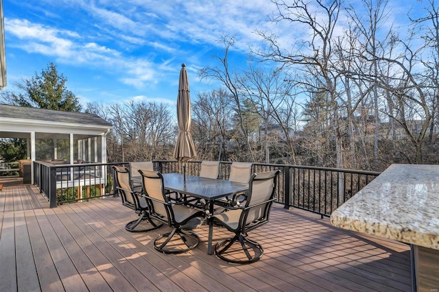 wooden deck with a sunroom