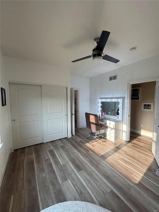 unfurnished office featuring ceiling fan and wood-type flooring