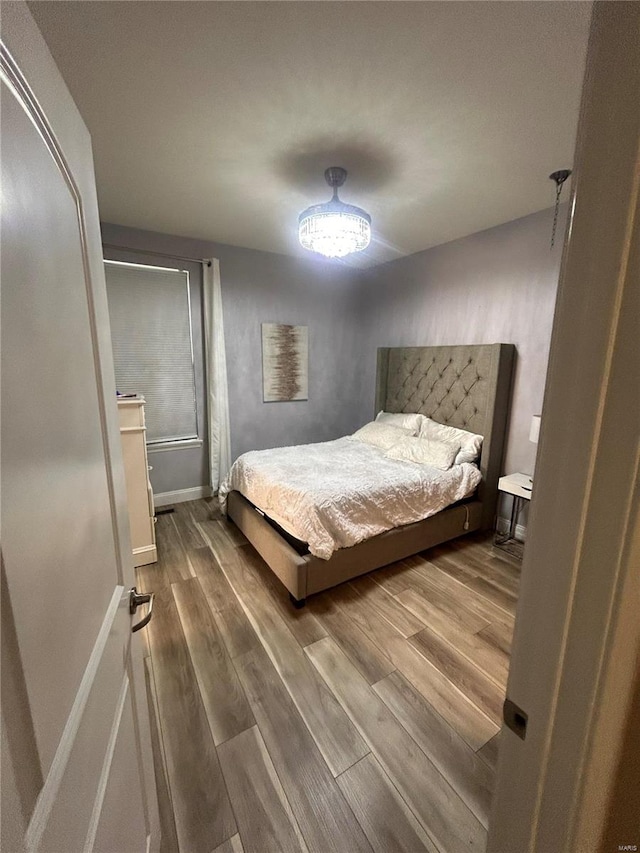 bedroom with hardwood / wood-style flooring