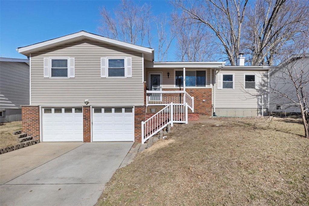 split level home featuring a garage and covered porch