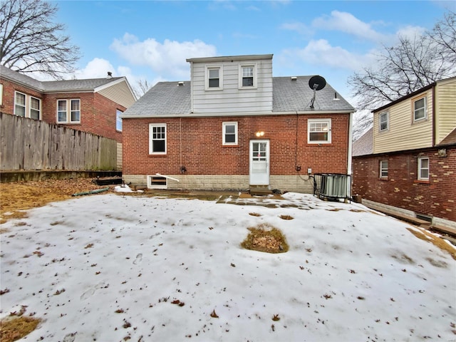 view of snow covered rear of property