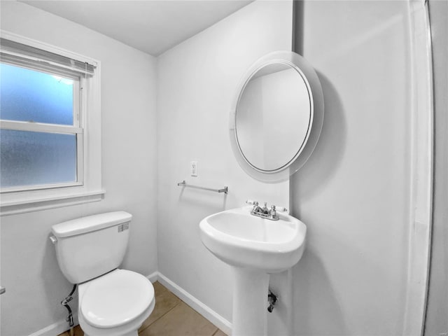 bathroom with toilet and tile patterned flooring