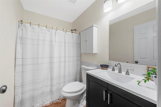 bathroom with backsplash, vanity, toilet, and a shower with curtain