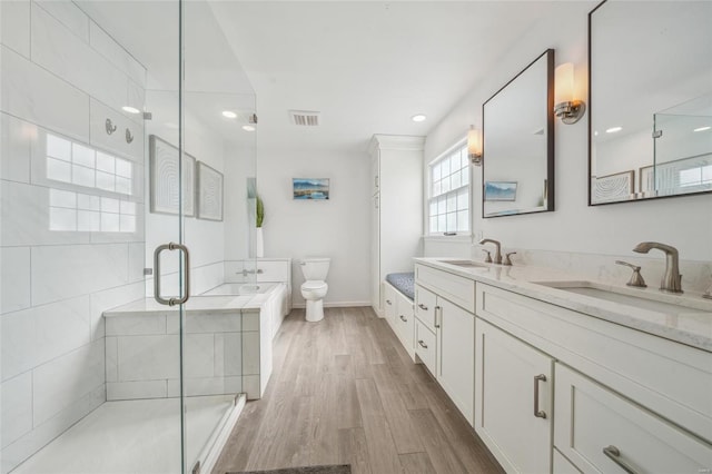 bathroom featuring an enclosed shower, vanity, hardwood / wood-style flooring, and toilet