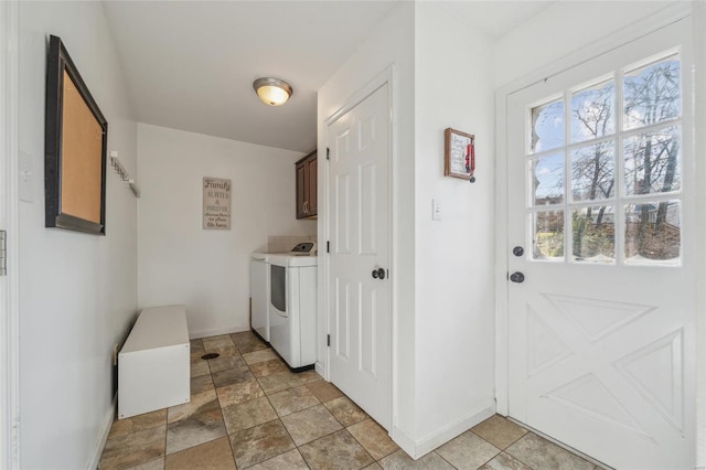 laundry area with washer and clothes dryer and cabinets