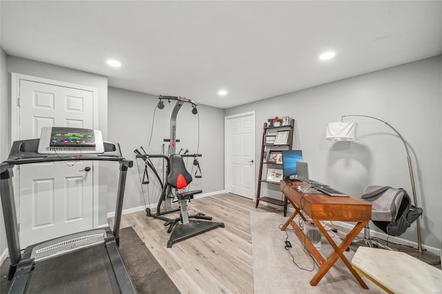 workout room featuring light wood-type flooring