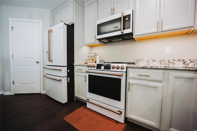 kitchen featuring dark wood-type flooring, high quality appliances, light stone counters, and white cabinets