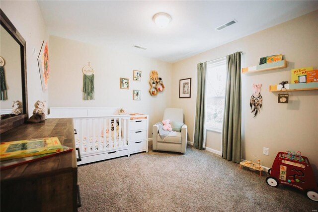 bedroom with a crib and carpet