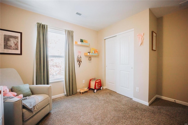 sitting room featuring plenty of natural light and carpet flooring