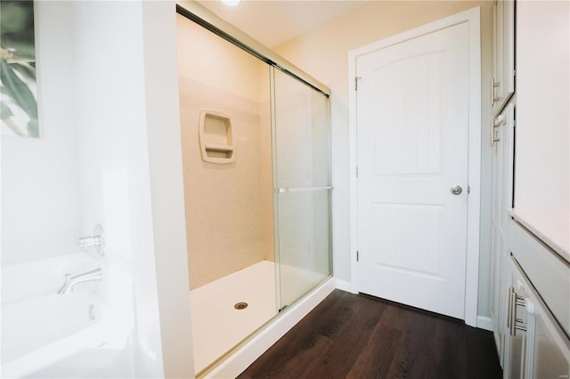 bathroom featuring an enclosed shower and hardwood / wood-style floors