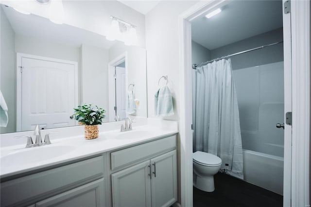 full bathroom with vanity, shower / bath combination with curtain, and toilet