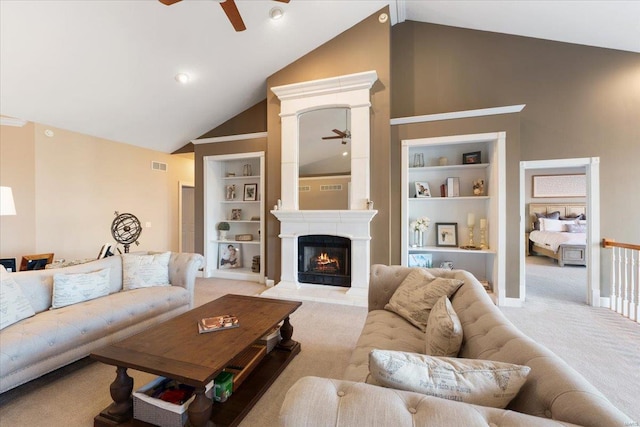 living area featuring carpet floors, visible vents, and built in features