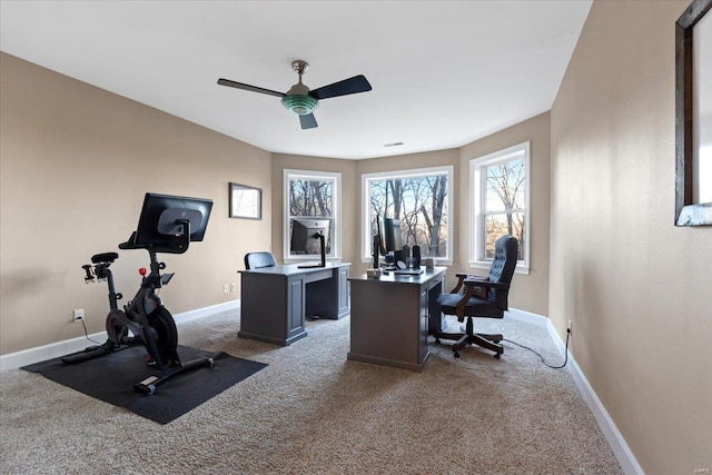 office area with light carpet, baseboards, and a ceiling fan