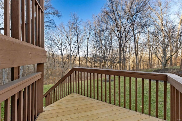 wooden deck featuring a yard