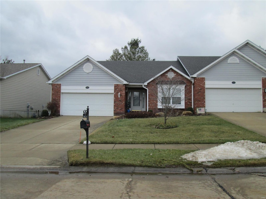 ranch-style house with a garage and a front lawn