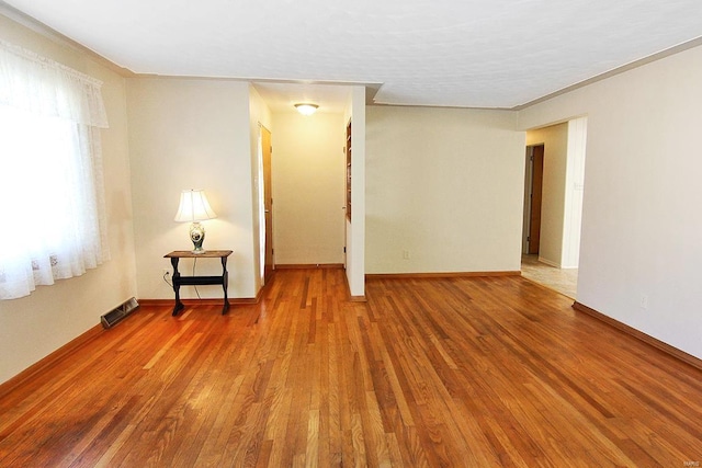 spare room with hardwood / wood-style floors