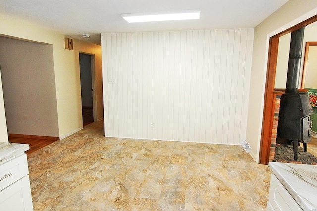 spare room featuring a wood stove