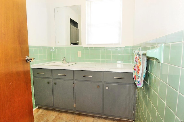 bathroom featuring vanity and tile walls