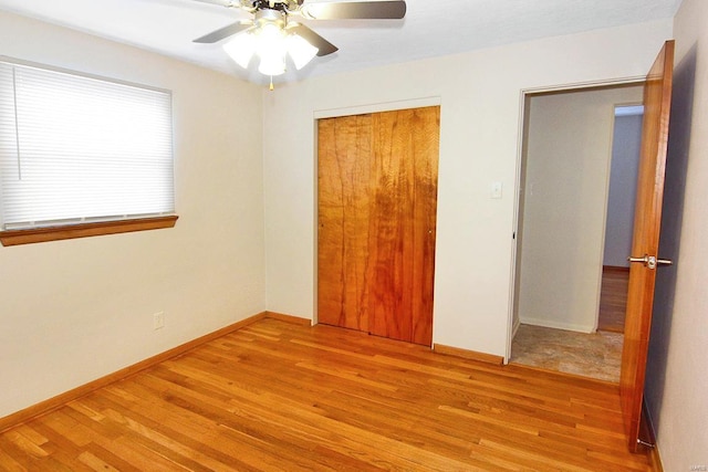 unfurnished bedroom with light hardwood / wood-style floors, a closet, and ceiling fan