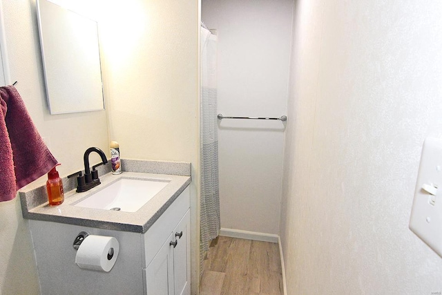 bathroom featuring hardwood / wood-style flooring and vanity