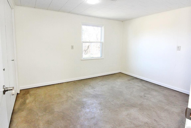 unfurnished room with concrete floors