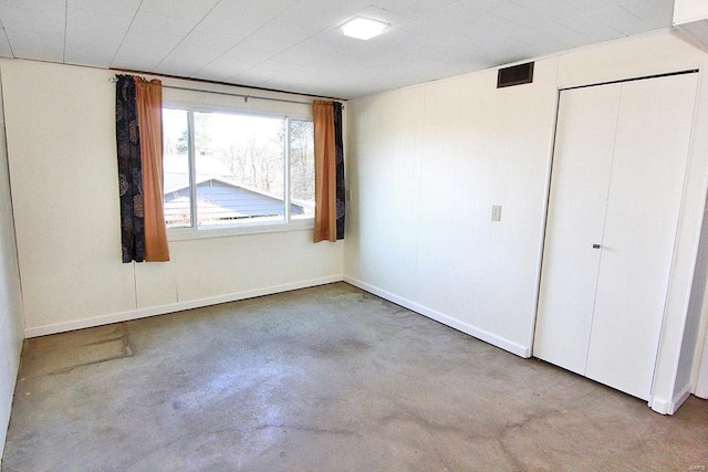 spare room with concrete floors