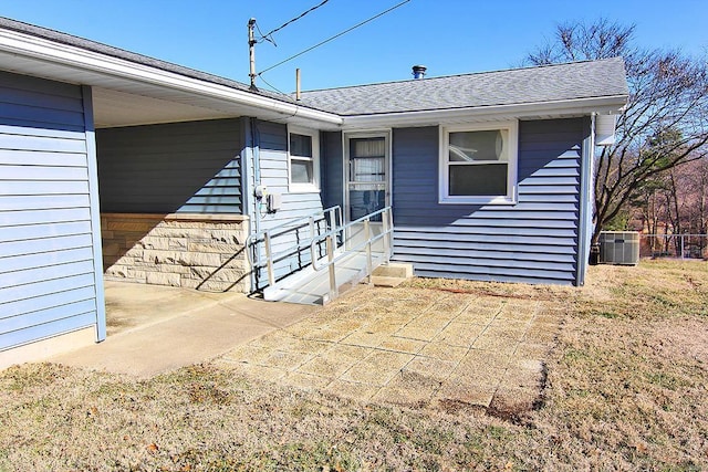 doorway to property with cooling unit and a patio area