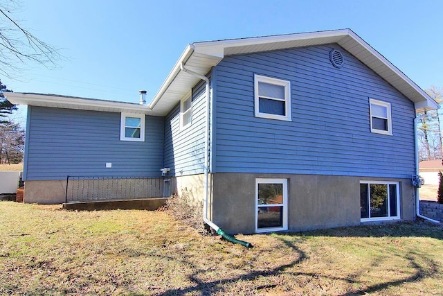 rear view of house with a lawn