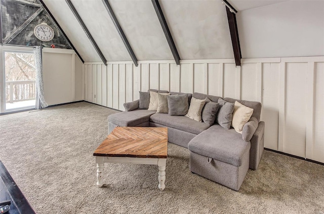 living area featuring carpet flooring, a decorative wall, and lofted ceiling with beams