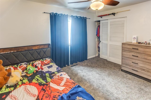 carpeted bedroom with ceiling fan and a closet