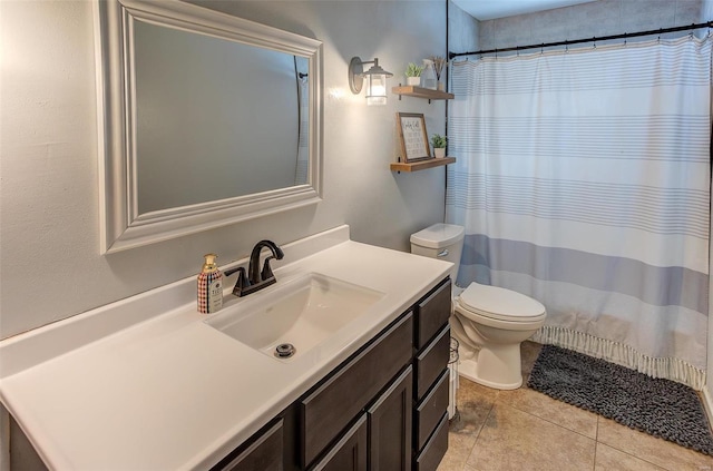 bathroom featuring tile patterned flooring, vanity, and toilet