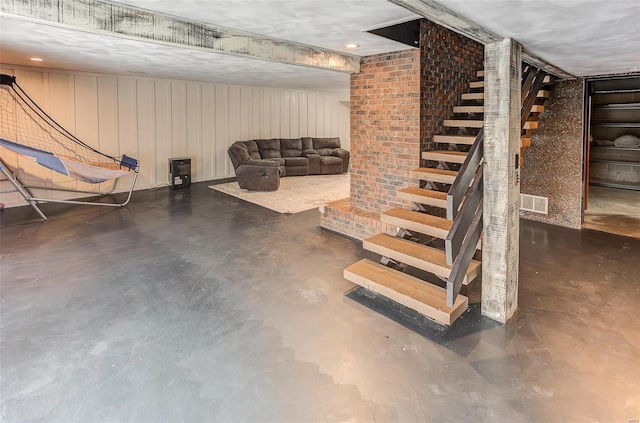 finished basement with visible vents and stairway