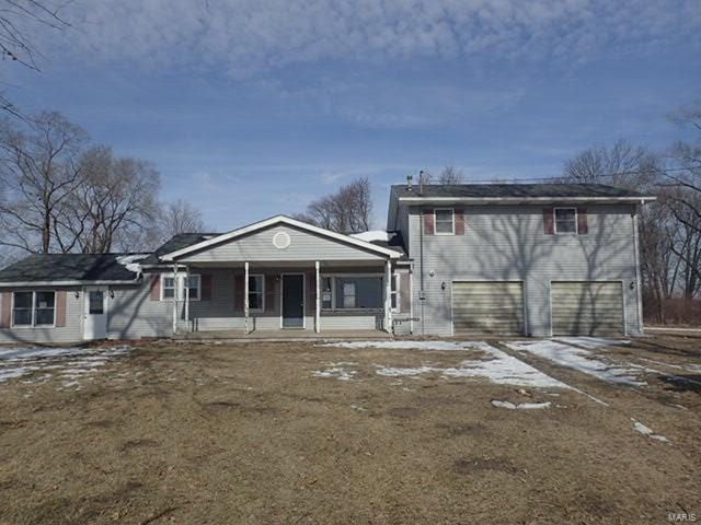 view of front facade with a garage and covered porch