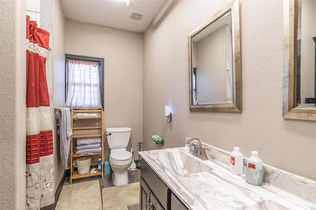 bathroom featuring vanity, toilet, and wood-type flooring