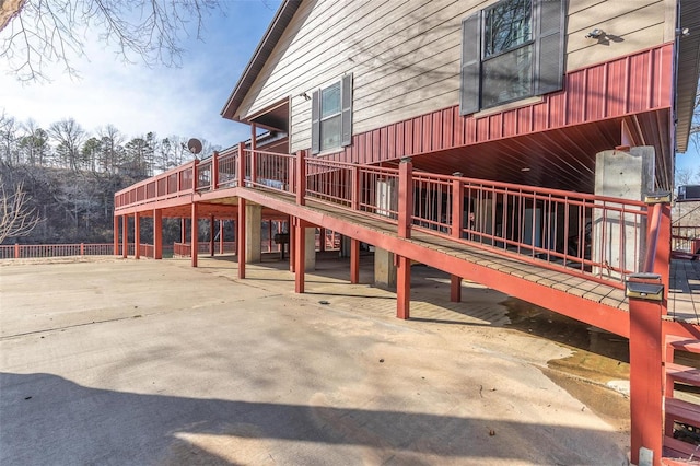 exterior space with a wooden deck and a patio